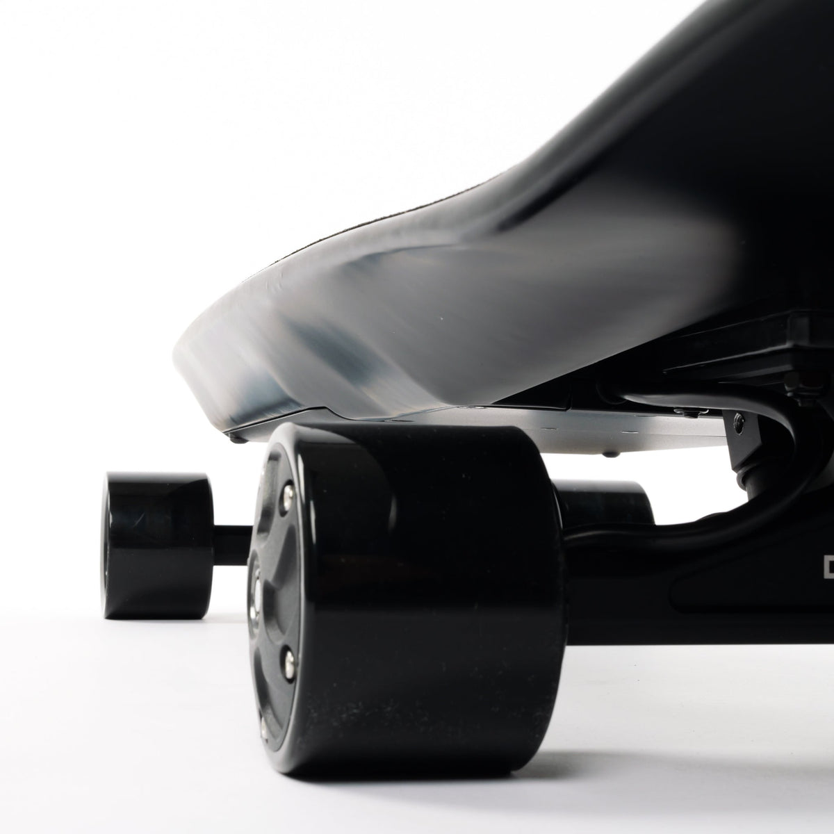 Close-up of an ONSRA electric skateboard truck with black street wheel