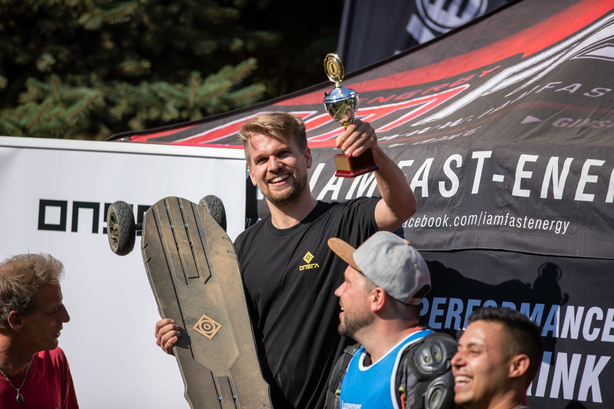 ONSRA team celebrating with a trophy and a Challenger at a race
