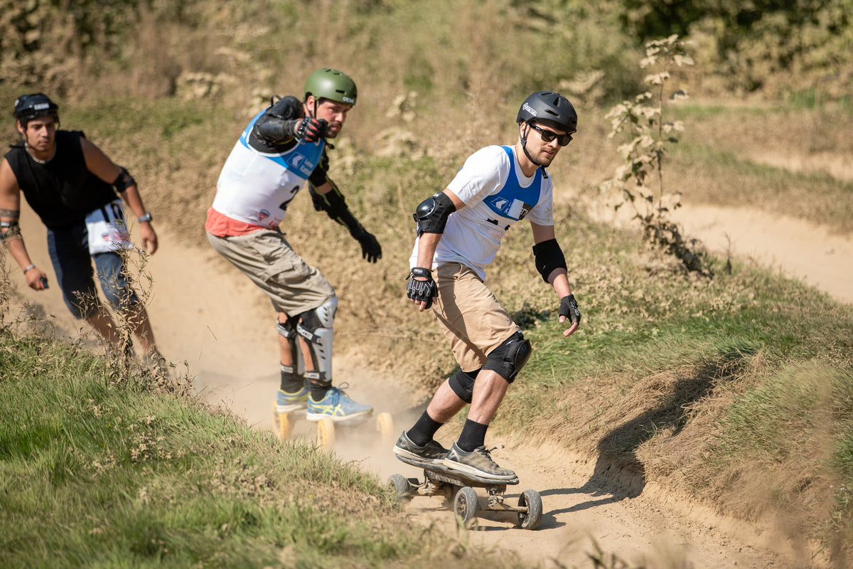 Riders racing ONSRA Challenger All-Terrain boards on a dirt track
