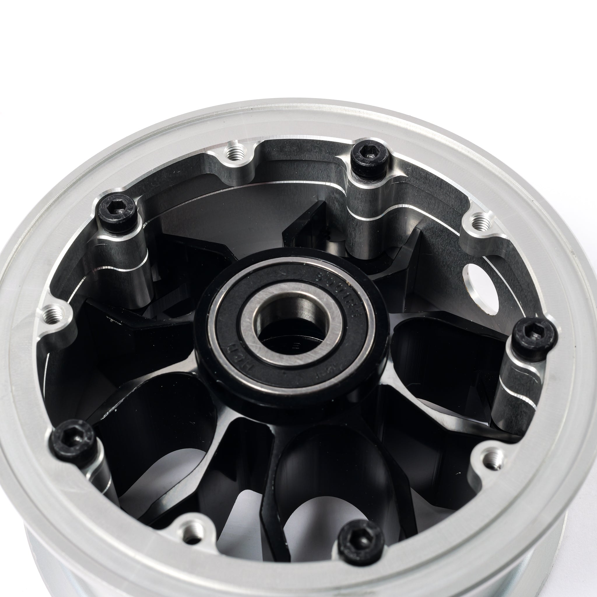 Rear view of CNC electric skateboard hub showing precision machined pulley mounting points and integrated bearing seat