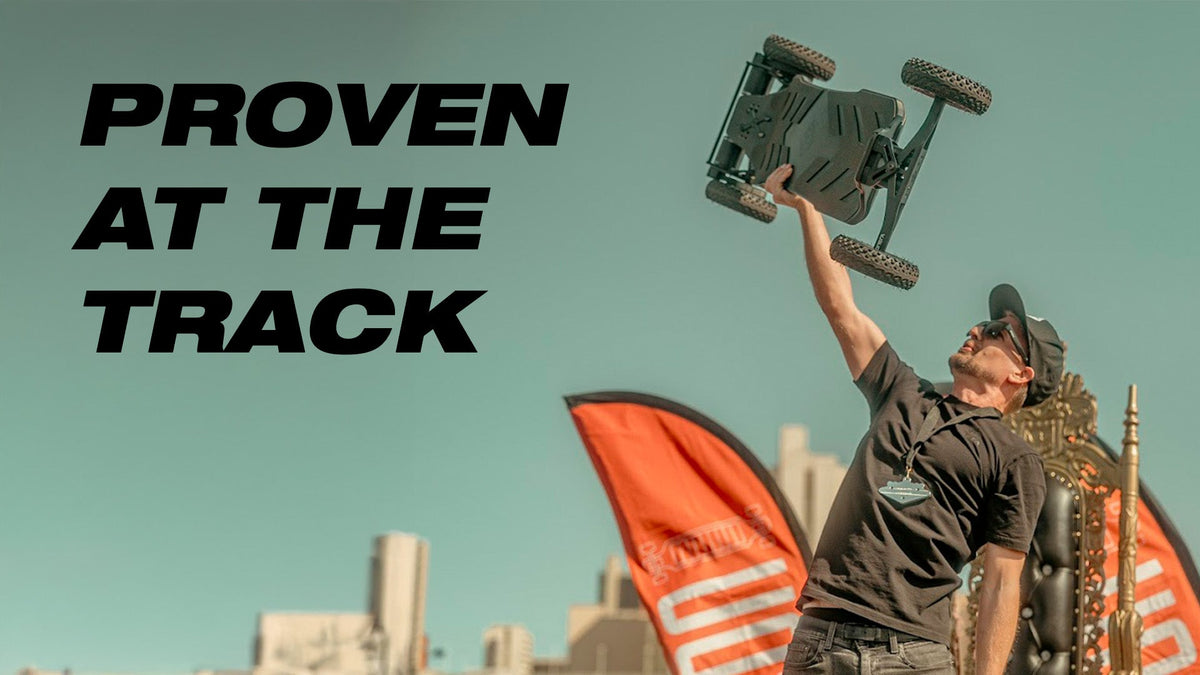 Rider lifting an ONSRA VELAR at a race – "Proven at the track"