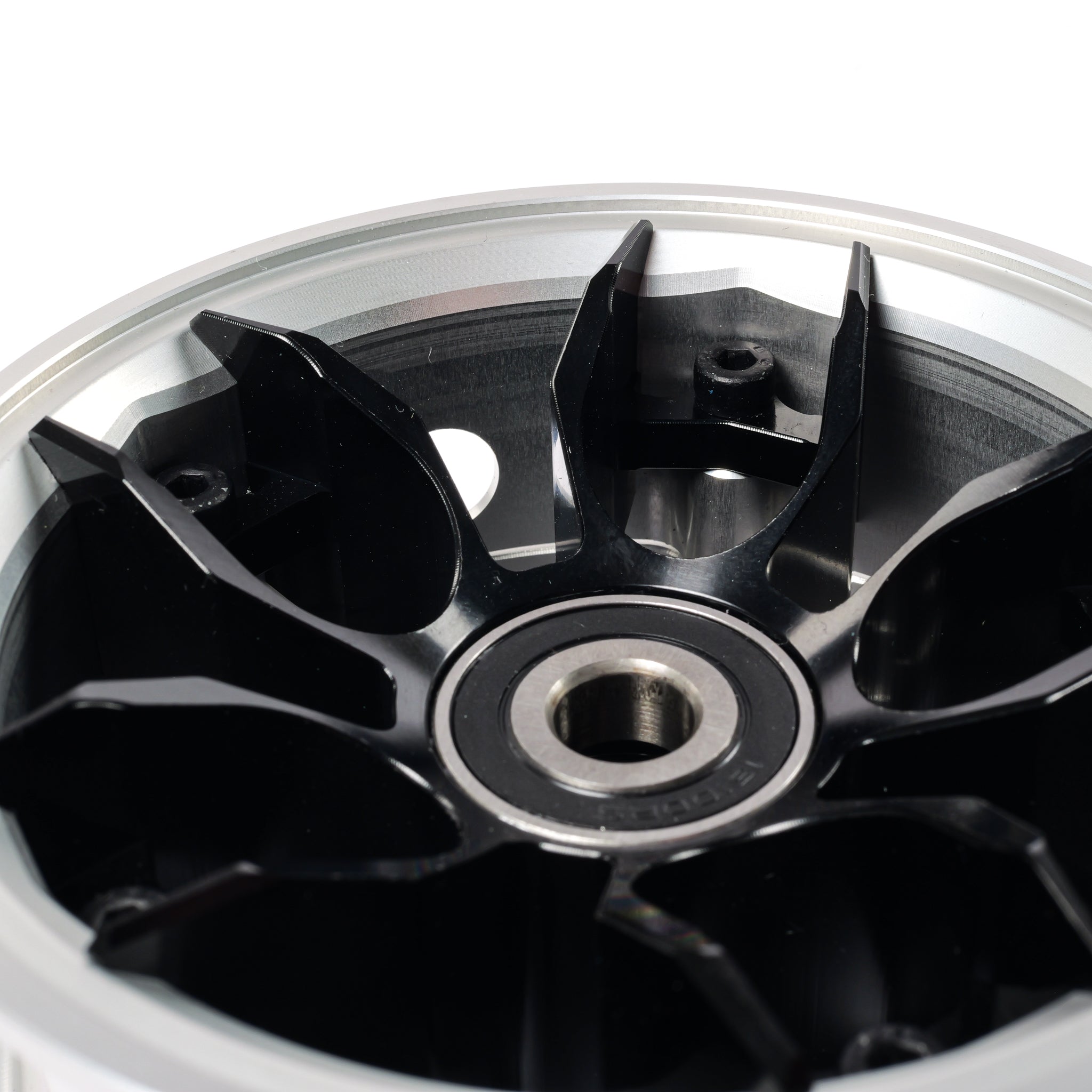 Close-up of black CNC wheel hub center with reinforced spoke design for high power electric skateboards